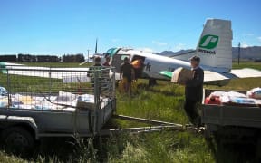 A plane is loaded up to get supplies out to farmers.