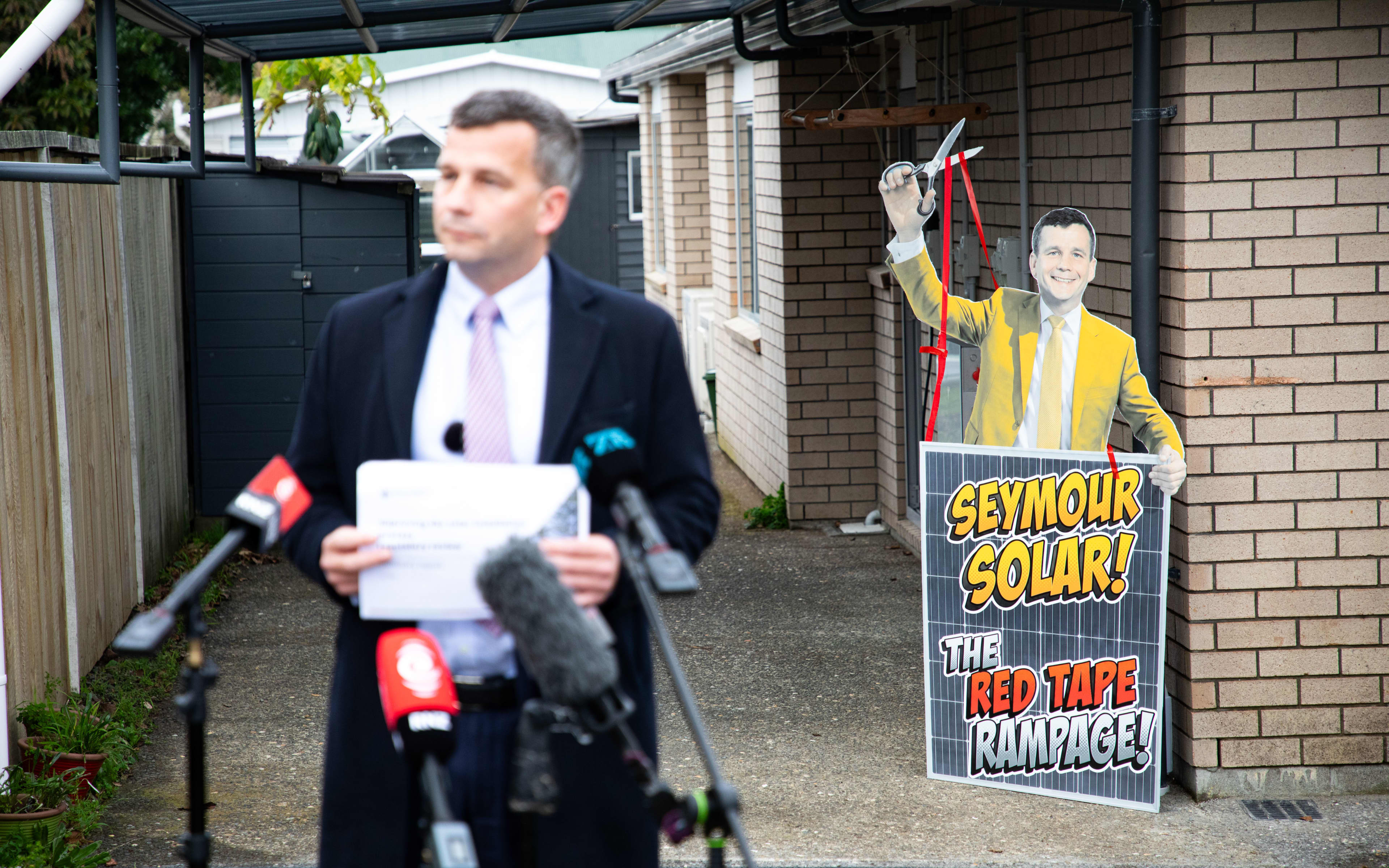 Minister for Regulation David Seymour presenting a review of solar panel regulations at a home powered by solar