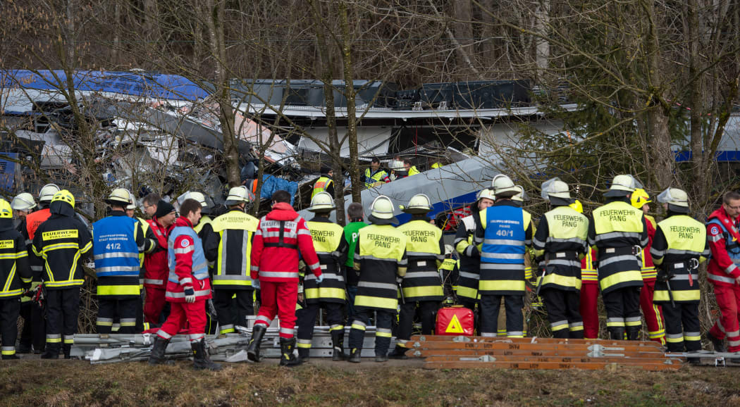 Firefighters and emergency doctors work at the site of a train accident near Bad Aibling, southern Germany, on February 9, 2016.