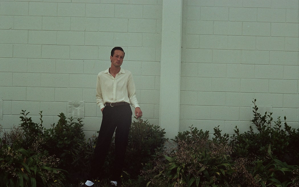 Marlon Williams poses with his hand tucked loosely in his pocket