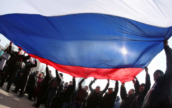 Pro-Russian protesters wave a Russian flag during a rally in the industrial Ukrainian city of Donetsk.