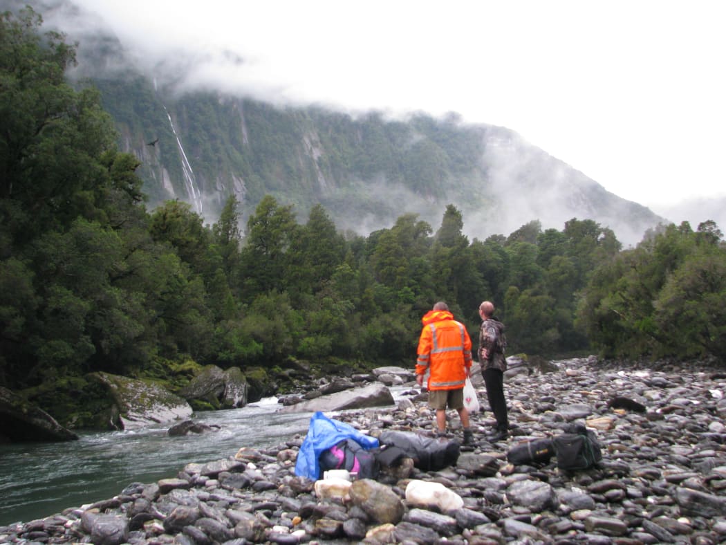 Members of a search party take stock after being dropped by helicopter into the Jacobs River area of the West Coast.