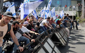 Protesters break police barricades during a demonstration against the Israeli government's controversial justice reform bill in Tel Aviv on 1 March, 2023.