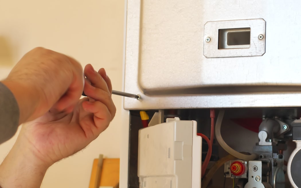 Man engineer and gas heater. Repair and work scene.