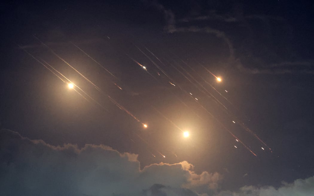 This picture shows projectiles being intercepted by Israel near the northern city of Baqa al-Gharbiya on October 1, 2024. Air raid sirens sounded in central Israel on October 1, the military said, a day after the army launched ground operations into southern Lebanon targeting Hezbollah positions. 