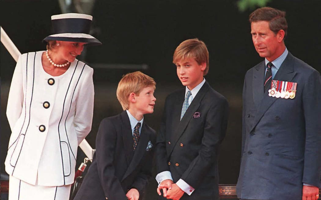 Princess Diana (left), her sons Harry and William, and Prince Charles watch the parade march past as part of the commemorations of VJ Day 19 August in London. The commemoration was held outside Buckingham Palace and was attended by 15,000 veterans and tens-of-thousands of spectators.