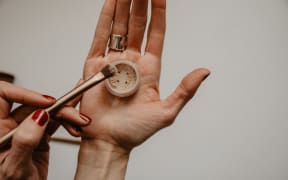 woman's hands with makeup product
