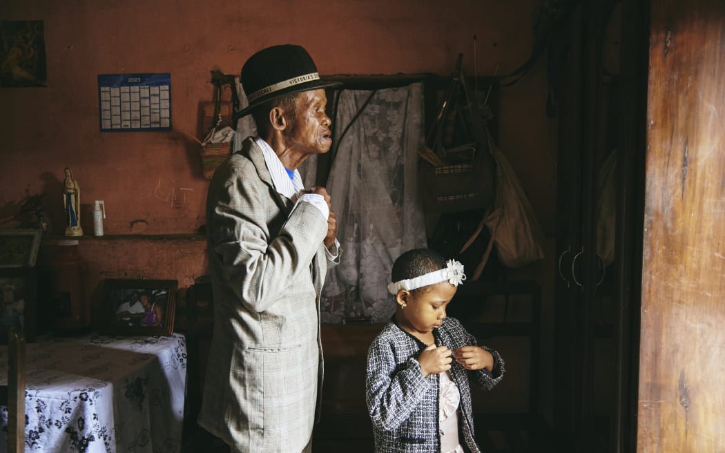 Dada Paul Rakotazandriny (91), who is living with dementia, and his granddaughter, Odliatemix Rafaraniriana (5), get ready for church on Sunday morning at his home in Antananarivo, Madagascar. 12 March 2023