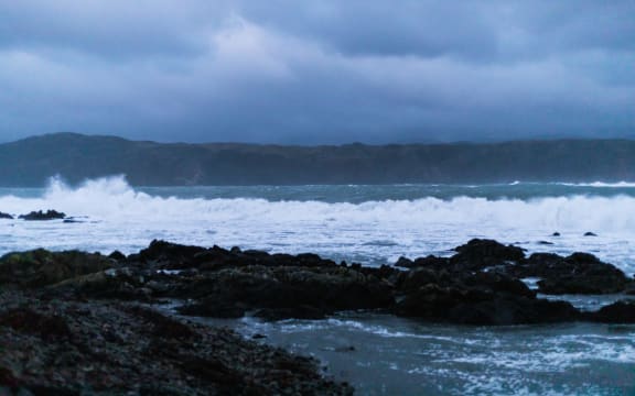 Waves break on Breaker Bay this evening as the size of the swell increases.