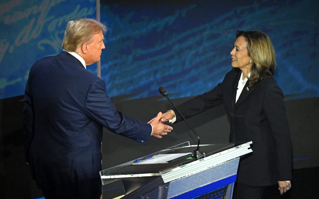 US Vice President and Democratic presidential candidate Kamala Harris (R) shakes hands with former US President and Republican presidential candidate Donald Trump during a presidential debate at the National Constitution Center in Philadelphia, Pennsylvania, on September 10, 2024. (Photo by SAUL LOEB / AFP)