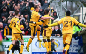 Sutton United players celebrate.