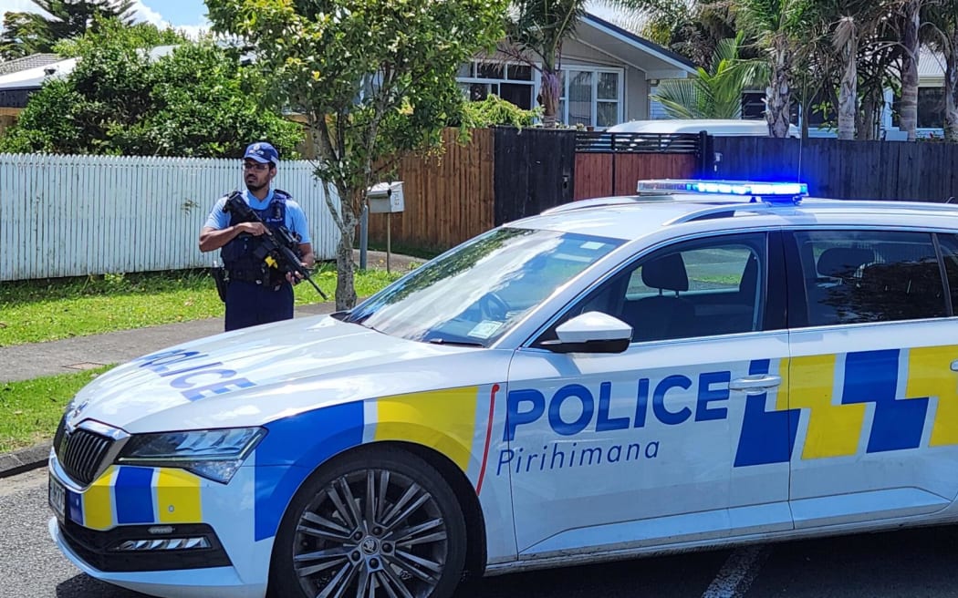 An armed police officer on Addington Ave in Manurewa, Auckland.