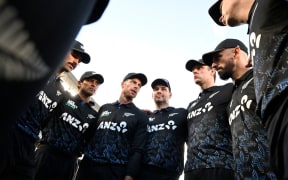 New Zealand cricket captain Mitchell Santner talks to his players.