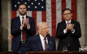 US Speaker of the House Mike Johnson (R-LA) and Vice President JD Vance (L) applaud as US President Donald Trump addresses a joint session of Congress at the US Capitol in Washington, DC, on March 4, 2025. (Photo by Win McNamee / POOL / AFP)
