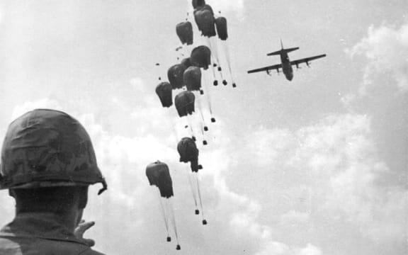 soldier with gun and plane flying