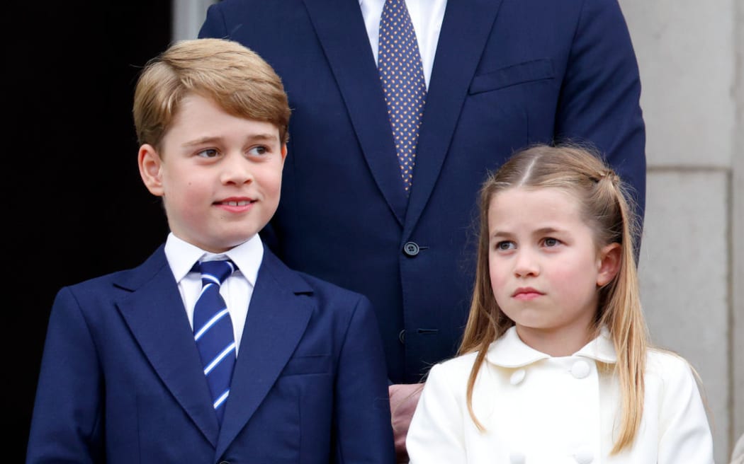 Prince George of Cambridge and Princess Charlotte of Cambridge stand on the balcony of Buckingham Palace following the Platinum Pageant on 5 June 2022 in London, England.