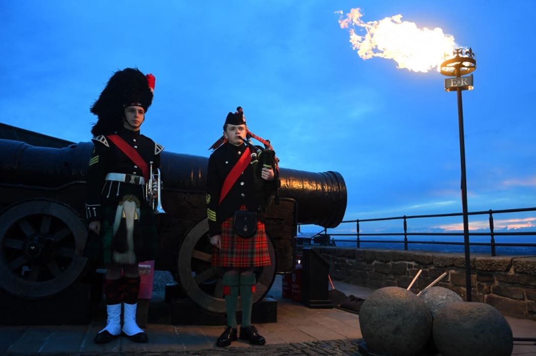 Army Cadet Sergeant Ciaran Cook (L) and Army Cadet Callum Lowther (R) attend a ceremony for the beacon lighting at Edinburgh Castle, in Edinburgh, on June 2, 2022, as part of Queen Elizabeth II's platinum jubilee celebrations. - More than 2,800 beacons are lit at Buckingham Palace and across the UK, including atop the four highest peaks, as well as on the Channel Islands, the Isle of Man, and British Overseas Territories. Flaming tributes will be seen in 54 Commonwealth capitals across five continents, from Tonga and Samoa in the South Pacific to Belize in the Caribbean.