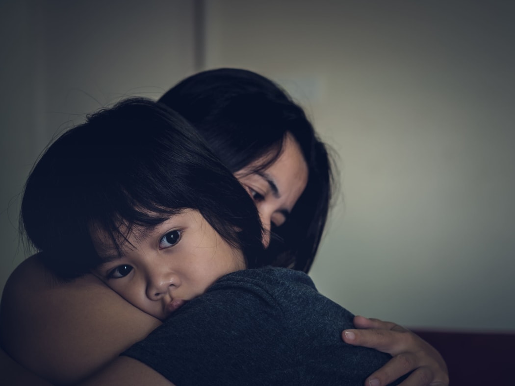 83600651 - mother and child, cute little boy resting on her mother's shoulder. young mother holding her sad boy at home.