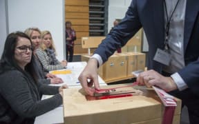 A member of the polling commission prepares the ballots for counting at a polling station in Kopavogur on October 29
