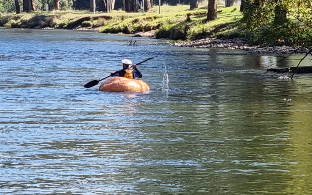 Adam Farquharson paddling a pumpkin