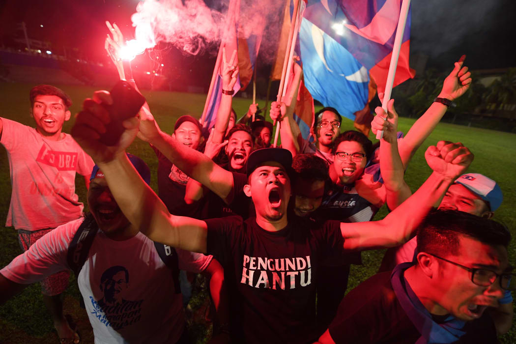 Supporters of former Malaysian prime minister and opposition candidate Mahathir Mohamad celebrate in Kuala Lumpur.