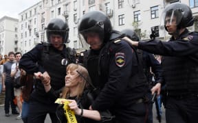 Russian police officers detain Maria Baronova, a coordinator of Khodorkovsky's Open Russia organization as she participates at the unauthorized opposition rally in Tverskaya street in central Moscow on June 12, 2017.