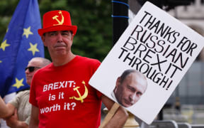 Anti-Brexit activist Steve Bray, wearing a hat and t-shirt featuring a hammer and sickle, demonstrates outside the Houses of Parliament in London, England, on July 22, 2020.