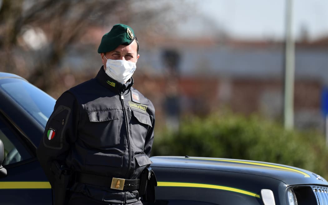 Italian police officer at a checkpoint at the small town of Zorlesco, southeast of Milan, on February 26, 2020.