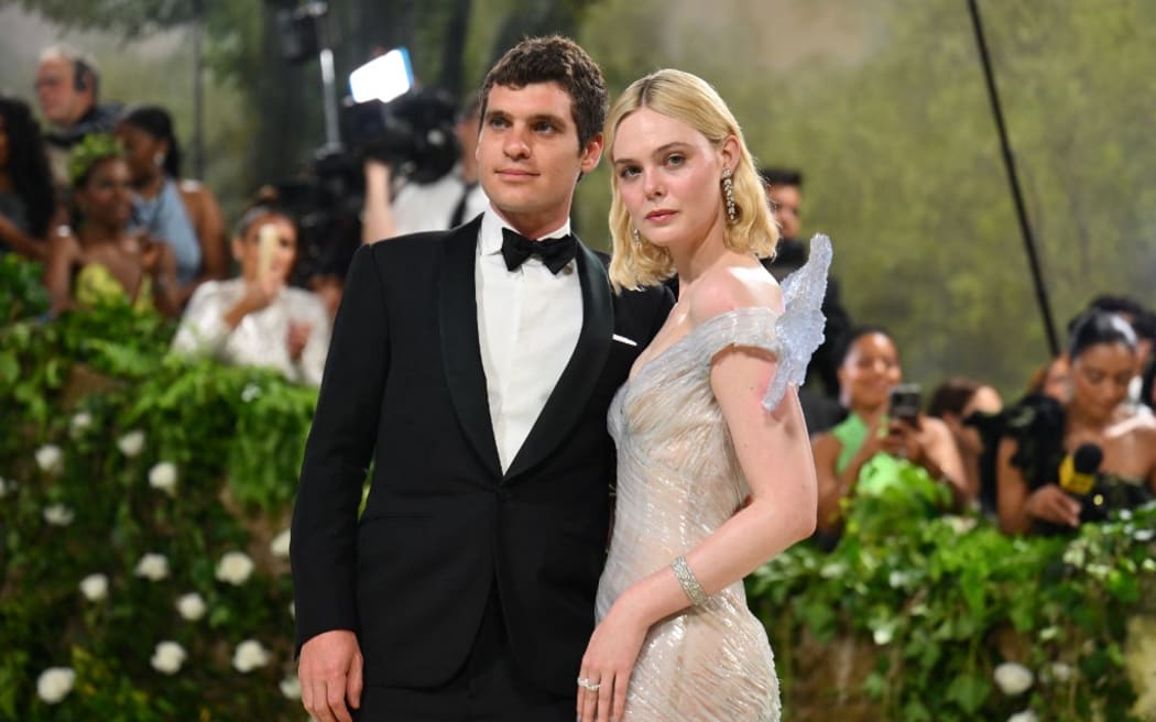 US actress Elle Fanning (R) and CEO of Rolling Stone Gus Wenner arrive for the 2024 Met Gala at the Metropolitan Museum of Art on May 6, 2024, in New York. The Gala raises money for the Metropolitan Museum of Art's Costume Institute. The Gala's 2024 theme is “Sleeping Beauties: Reawakening Fashion.” (Photo by Angela WEISS / AFP)
