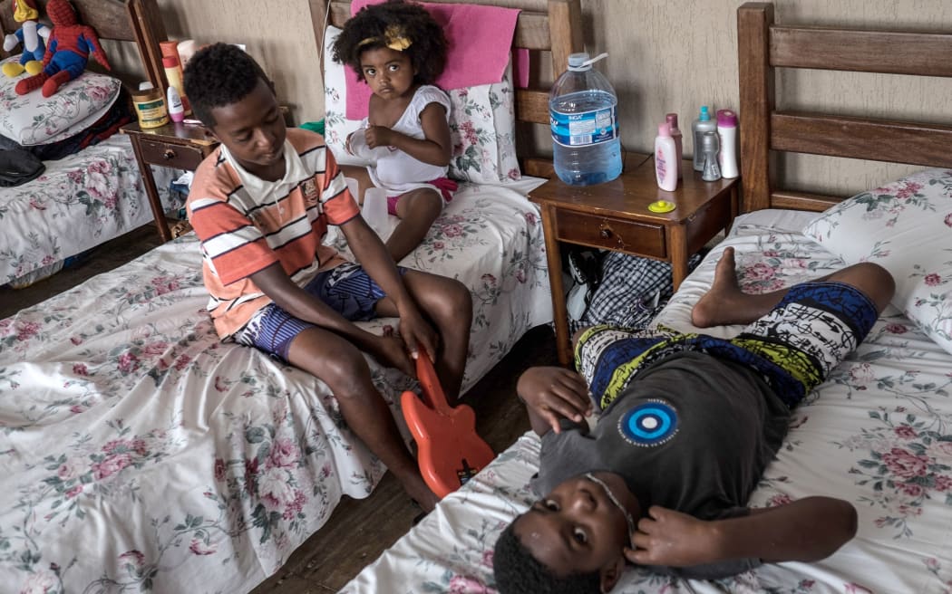 A group of survivors of the mudslide that buried their village, Bento Rodrigues, in Mariana, Brazil, on 8 november, 2015, Brazil. AFP PHOTO / CHRISTOPHE SIMON
