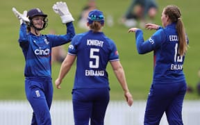 England celebrate the final wicket to win the game and series during the second One Day International women's cricket match between New Zealand and England at Seddon Park in Hamilton.