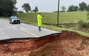 This handout picture released on August 24, 2022, courtesy of the Mississippi Highway Safety Patrol shows Highway 489 washed away due to flood water in Newton County near Marrow Road, Mississippi. - Mississippi officials declared a health emergency Tuesday after historic flooding damaged treatment systems and left 180,000 people in the state capital Jackson without safe drinking water. (Photo by Handout / Mississippi Highway Safety Patrol H / AFP) / RESTRICTED TO EDITORIAL USE - MANDATORY CREDIT "AFP PHOTO /  Mississippi Highway Safety Patrol H " - NO MARKETING - NO ADVERTISING CAMPAIGNS - DISTRIBUTED AS A SERVICE TO CLIENTS