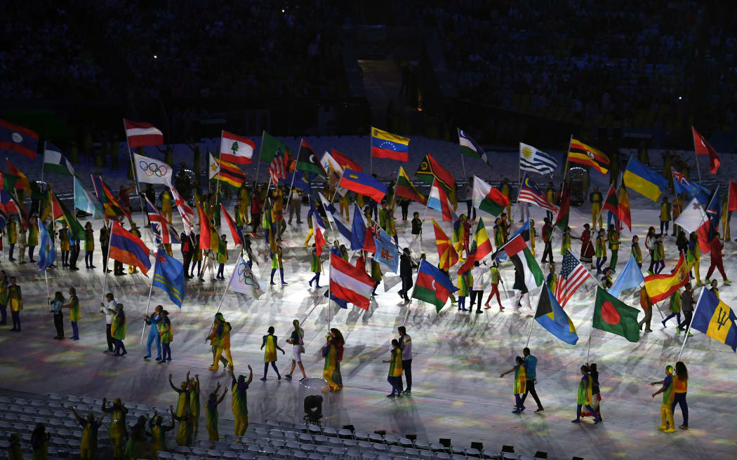 Flagbearers for participating nations walk around the centre of Maracana Stadium at the Rio Olympics closing ceremony 2016.