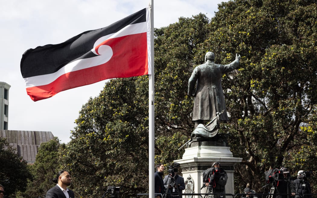 The Tino Rangatiratanga flag flies at Parliament next to the statue of early Premier Dick Seddon. The event was on 14 September 2022 to mark the 50th anniversary of the Māori language petition.