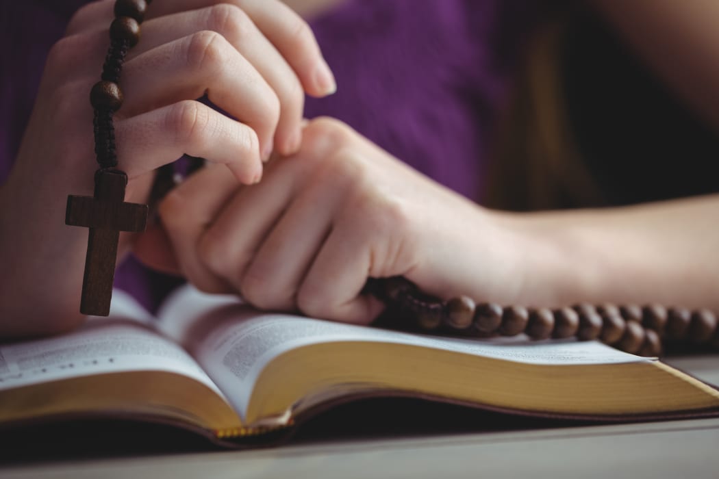 Woman praying with her bible.