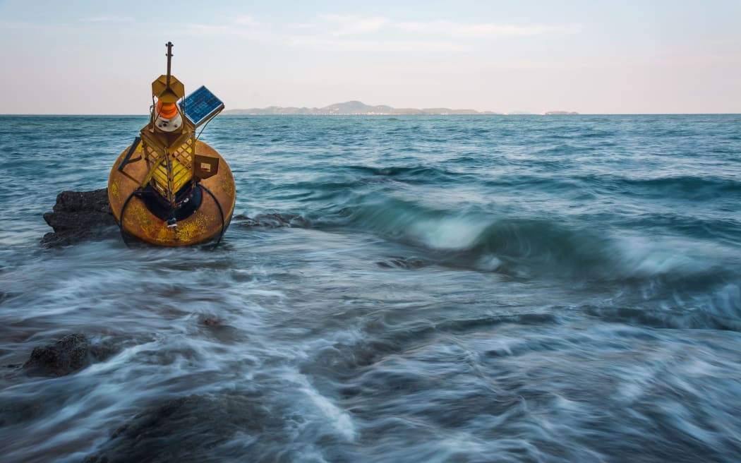 Navigation buoy Aground on the beach .