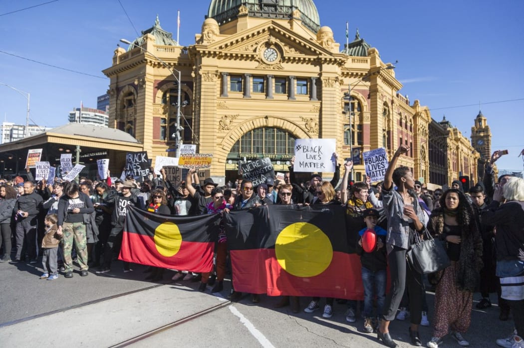 Protestors hold banners and chant slogans during a Black Lives matter rally in Melbourne, Australia.