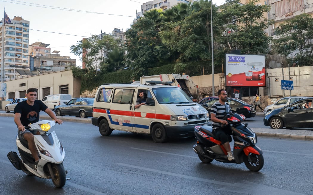 A Lebanese Red Cross ambulance rushes wounded people to a hospital in Beirut on September 17, 2024, after explosions hit locations in several Hezbollah strongholds around the country amid ongoing cross-border tensions between Israel and Hezbollah fighters. Hundreds of people were wounded when Hezbollah members' paging devices exploded simultaneously across Lebanon on September 17, in what a source close to the militant movement said was an "Israeli breach" of its communications. (Photo by Ibrahim AMRO / AFP)