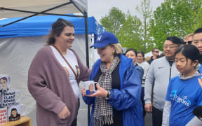 Judith Collins (centre) with Lisa Stirling (left) holding the mug with her face on it.