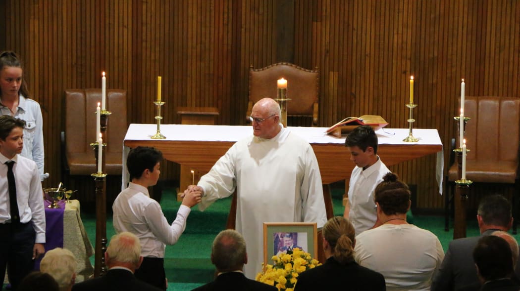 The requiem mass is being held at the Sacred Heart Catholic Church.