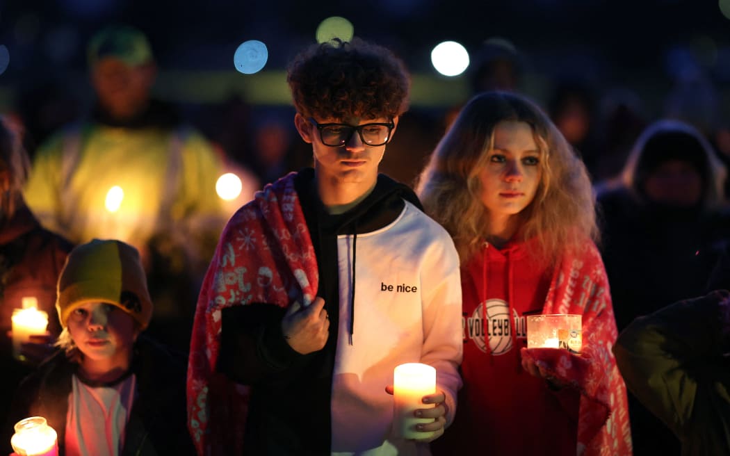 PERRY, IOWA - JANUARY 04: Community members gather in Wiese park for a candlelight vigil following the morning shooting at the Perry Middle School and High School complex on January 04, 2024 in Perry, Iowa. A 17-year-old student identified by authorities as Dylan Butler opened fire at the school on the first day back from the winter break, killing a student and wounding five others. Investigators say they believe the shooter died of a self-inflicted gunshot.   Scott Olson/Getty Images/AFP (Photo by SCOTT OLSON / GETTY IMAGES NORTH AMERICA / Getty Images via AFP)