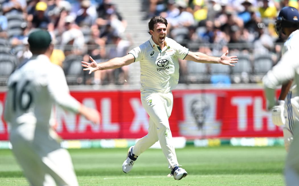 Mitch Marsh of Australia celebrates the wicket of Washington Sundar of India.