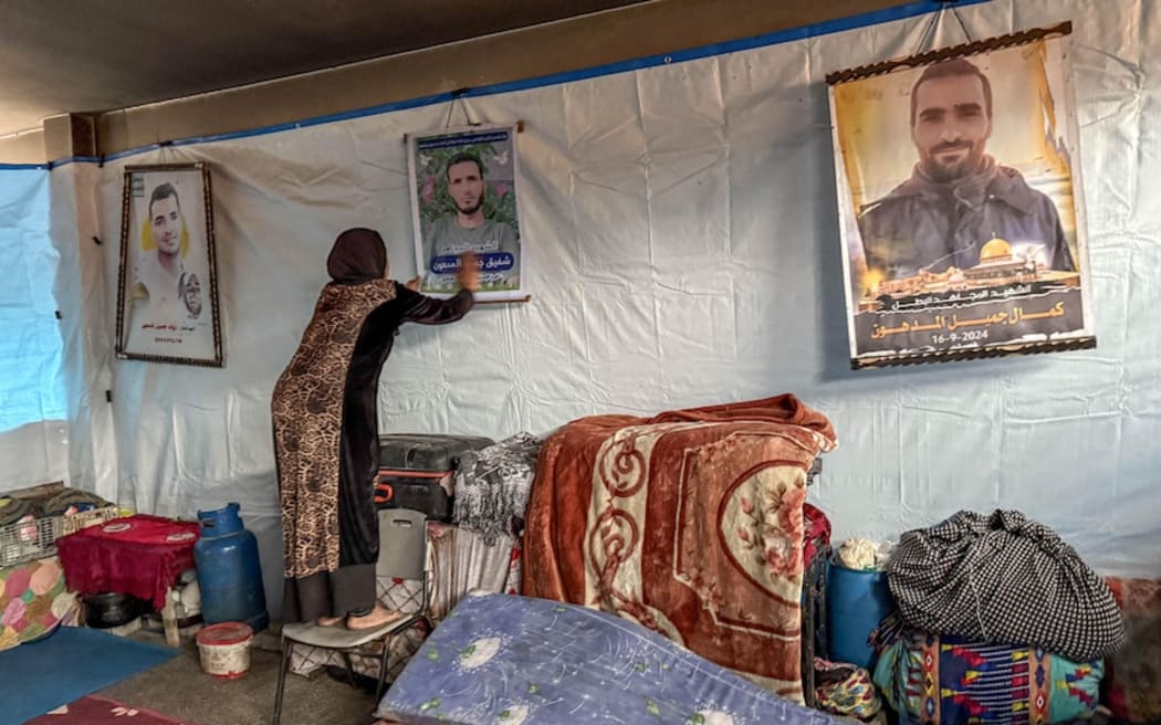 Amal Ashraf Al Shafa'a has photos of her three dead sons on the wall of her home.