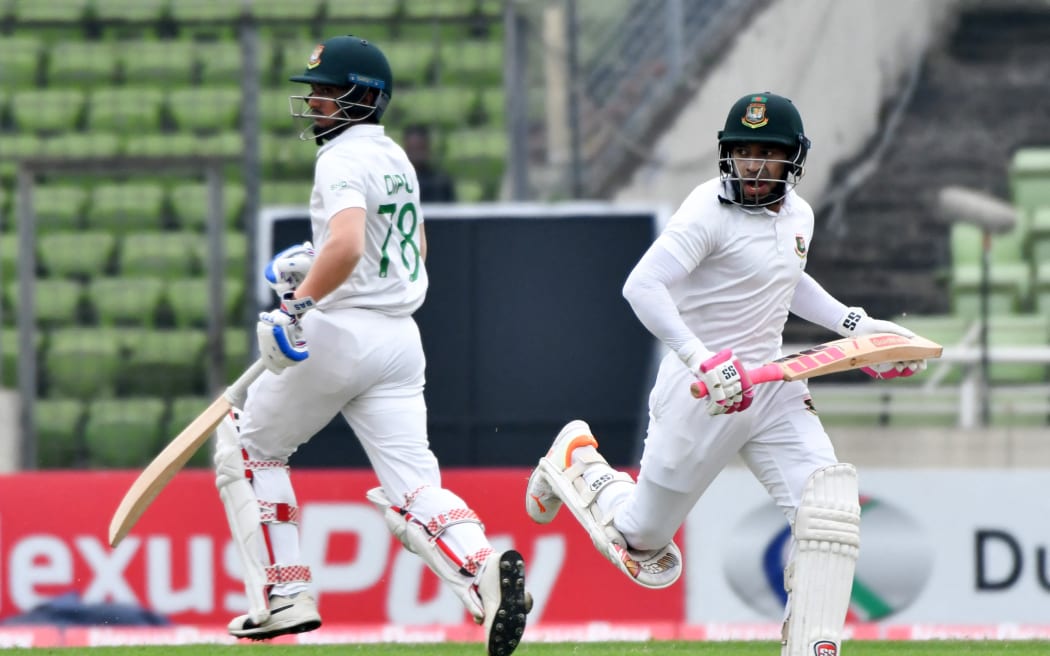 Bangladesh’s Mushfiqur Rahim (R) and Shahadat Hossain Dipu (L) run between the wickets during the first day of the second Test against New Zealand, Dhaka, 2023.