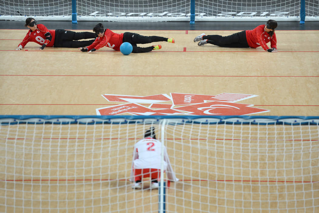Goalball players aim to hurl a ball past the opposing team into a goal running the width of the court.