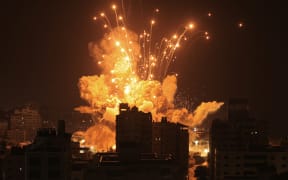 A missile explodes in Gaza City during an Israeli air strike on October 8, 2023. srael, reeling from the deadliest attack on its territory in half a century, formally declared war on Hamas Sunday as the conflict's death toll surged close to 1,000 after the Palestinian militant group launched a massive surprise assault from Gaza. (Photo by MAHMUD HAMS / AFP)