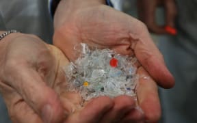 Plastic flakes, washed and broken up, ready to become semi molten before being extruded into plastic sheets for reincarnation as another plastic item at Flight Plastics.