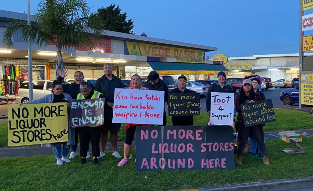 Members of Communities Against Alcohol Harm protesting outside a liquor store in Ōtara.