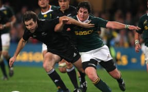 Conrad Smith and South Africa's Jacques Fourie during the test in Durban.