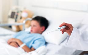 Sick boy in hospital bed.